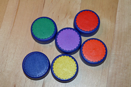 Make a simple DIY color matching game for your toddler using bottle caps.