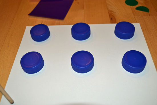 Make a simple DIY color matching game for your toddler using bottle caps.