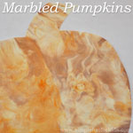 Use shaving cream and liquid watercolors to make Marbled Pumpkins and decorate for fall!