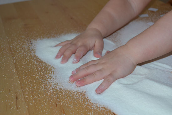 Salt tray sensory fun and an interesting pre-writing activity for toddlers.