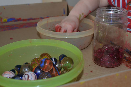 Painting with water beads and marbles - exploring the contrast between hard and soft while creating a lovely painting!