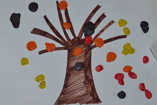 Simple fall tree craft with kid-made clay leaves.