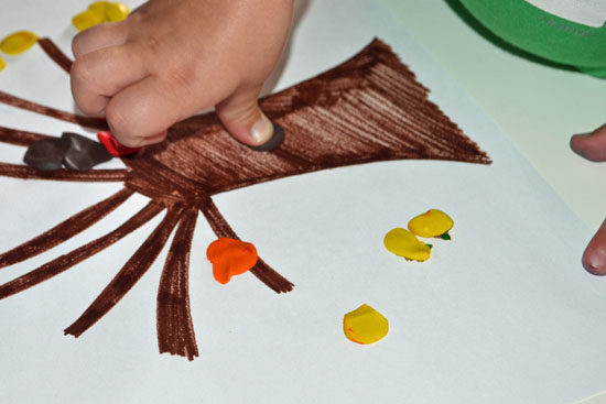 Simple fall tree craft with kid-made clay leaves.