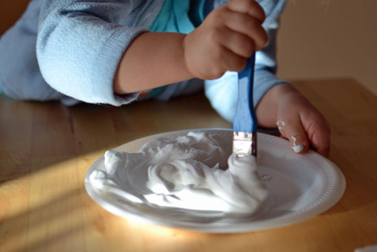 Use shaving cream puffy paint to make simple puffy snowmen decorations!