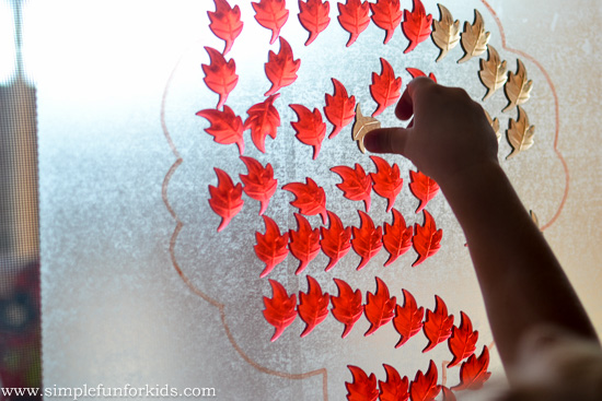 Play a quick and easy Contact Paper Fall Tree Counting Game with your preschooler with simple materials!