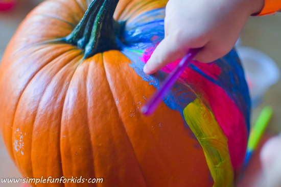 Pumpkin decoration: Make a fluorescent pumpkin with the blacklight on while painting - it looks SO COOL!
