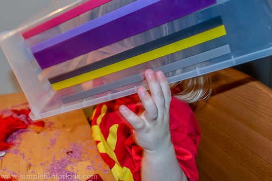 Simple rice-based Valentine's sensory bin with photos of loved ones for toddlers!