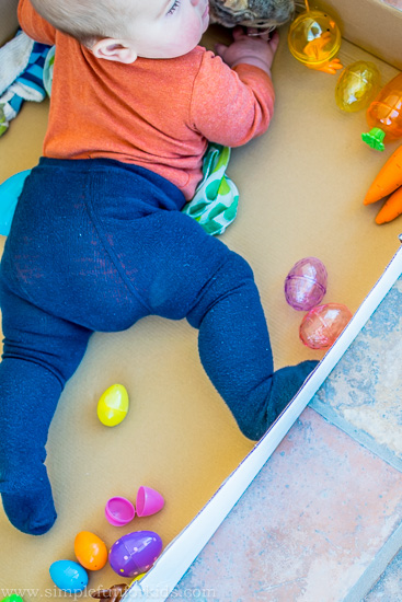 Baby can't sit up yet? Try a full body Easter sensory bin!