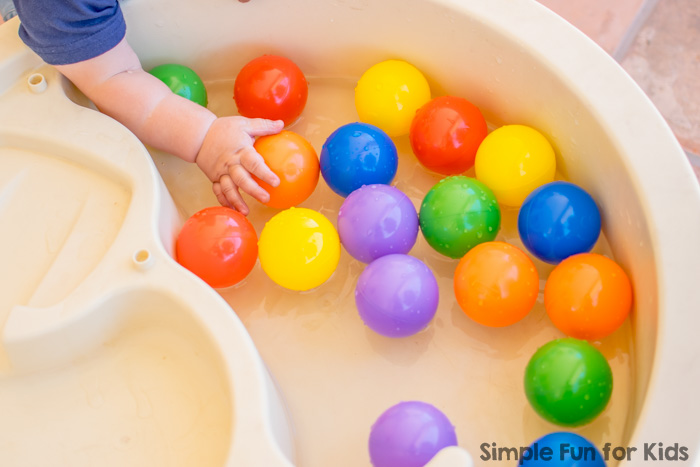 Simple Sensory Activities for Kids: Floating rainbow balls in the water table - colorful splashing fun for babies and toddlers!
