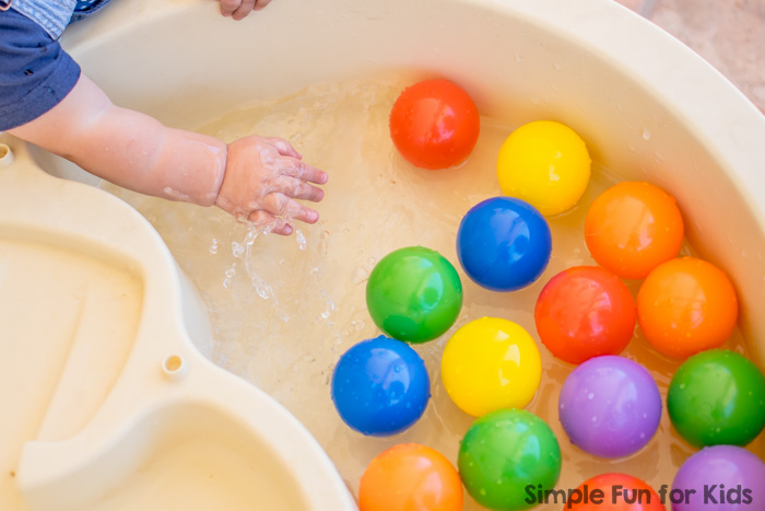 Simple Sensory Activities for Kids: Floating rainbow balls in the water table - colorful splashing fun for babies and toddlers!