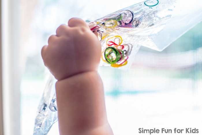 Simple Baby Safe Sensory Activity with Non-Baby Safe Items: Sensory Bag with Loom Bands, Glitter, and Sequins!