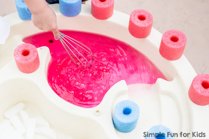 Water play for kids of all ages: Sensory soup with ice and pool noodles! Perfect simple summer fun!