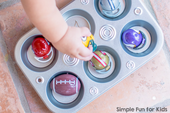 Sensory Activities for Kids: Quick and simple toddler play with mini football helmets in a muffin tin!