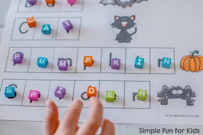 Literacy Activities for Preschoolers: Spelling Halloween words with beads and play dough! (Free printable included.)