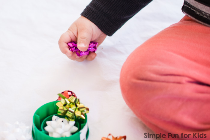 This time, my toddler found a Christmas surprise in a muffin tin! The set up was quick and simple, but it allowed for lots of fun sensory play and learning!
