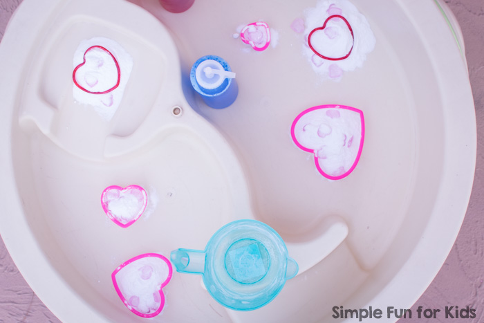 Super fun for toddlers and preschoolers on Valentine's Day or any day: Simple Baking Soda, Vinegar, and Hearts Sensory Play in the water table (or a sensory bin), perfect for siblings or play dates.