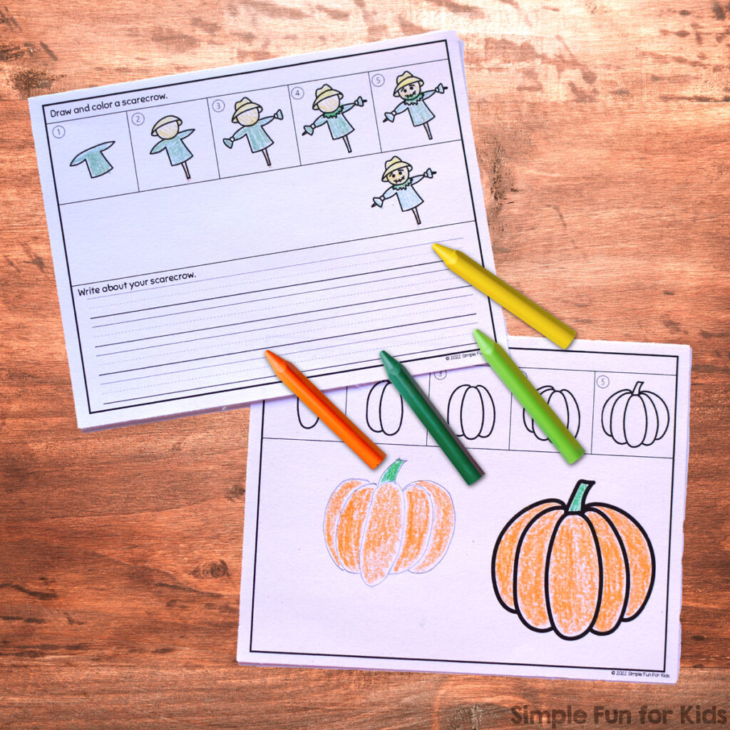 Picture of pumpkin and scarecrow directed drawing worksheets. They're on top of a brown table top with four crayons in orange, dark green, light green, and yellow.