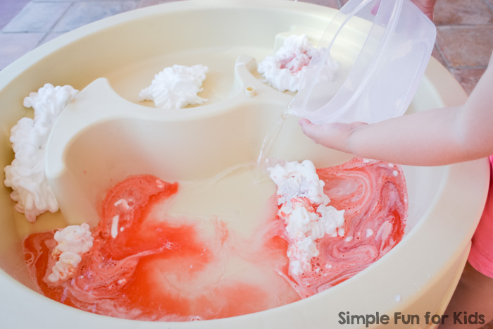 My toddler had awesome messy sensory fun with colored scented shaving cream in the water table! You won't believe how easy it was to clean it up afterward!