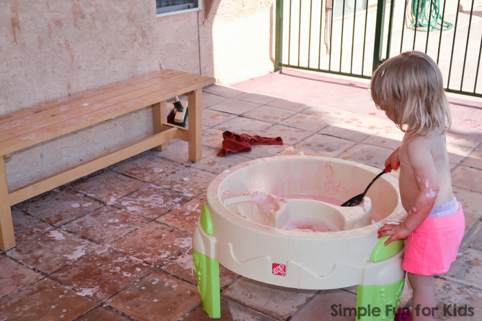 My toddler had awesome messy sensory fun with colored scented shaving cream in the water table! You won't believe how easy it was to clean it up afterward!