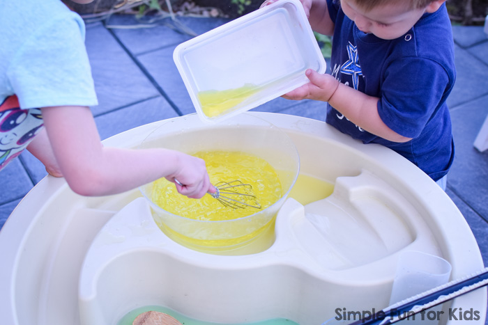 Simple sibling play with water: I set up a super simple stirring, pouring, and color mixing station in the water table for my toddler, and both he and my kindergartener had great fun with it!