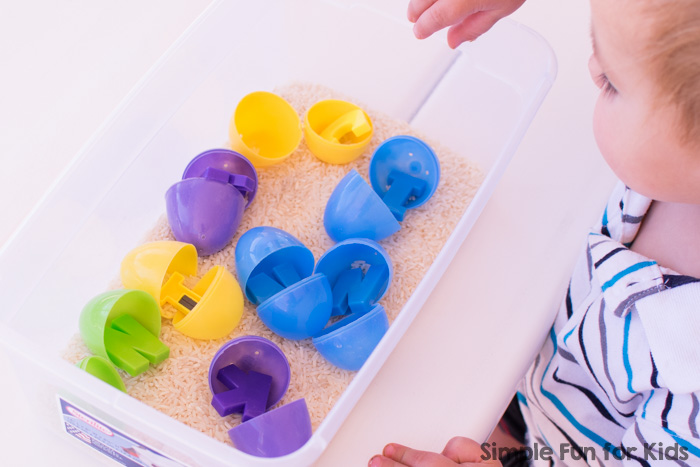 Quick and simple, hands-on, and sensory introduction to letters for toddlers: Learn the letters in my name with rice and plastic Easter eggs!