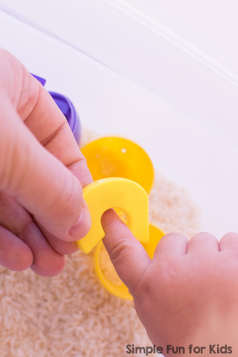 Quick and simple, hands-on, and sensory introduction to letters for toddlers: Learn the letters in my name with rice and plastic Easter eggs!