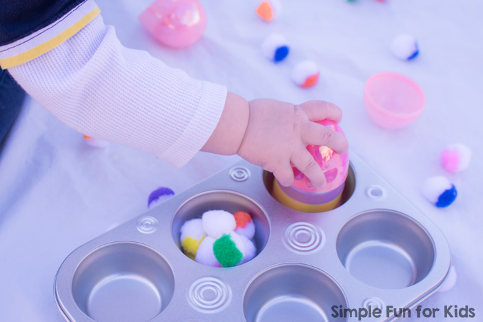 Some boredom busters never fail: This toddler play with plastic Easter eggs, pom poms, and a muffin tin used the simplest of materials, took less than a minute to put together, and kept my toddler happy and entertained!